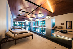 An image of a spa pool with luxury loungers and lighting