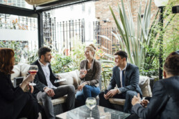 ADULTS DRINKING WINE WHILST NETWORKING