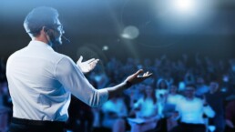 A motivational speaker in front of a crowd