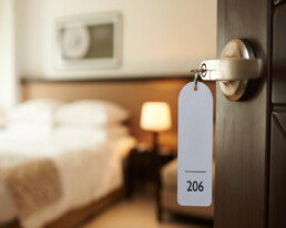 a close up image of an opened hotel room door with a key